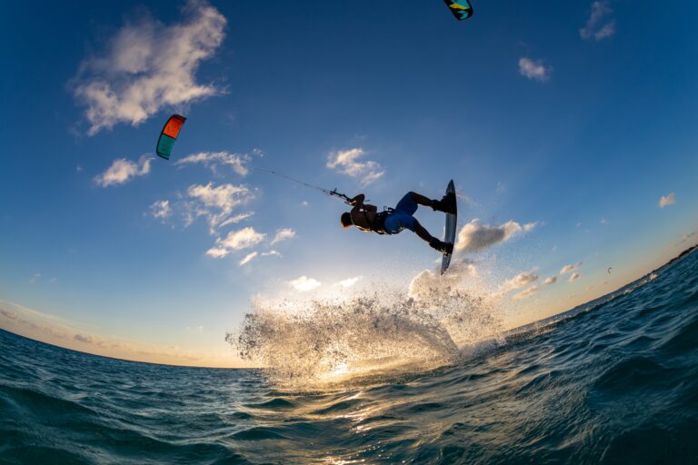 Person surfing and flying a parachute at the same time in Kitesurfing